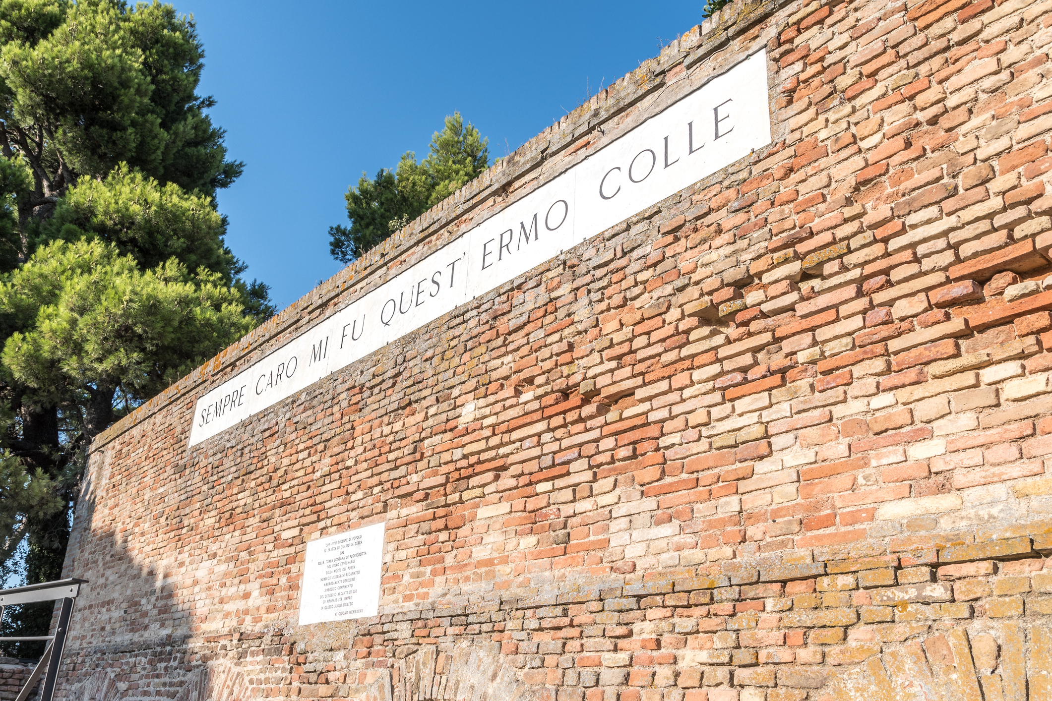 Recanati, Italy - August 13, 2021 - Famous wall of poet Giacomo Leopardi with text of his poem that means Always dear to me was this solitary hill AI e scuola, intervista a Mario Rasetti